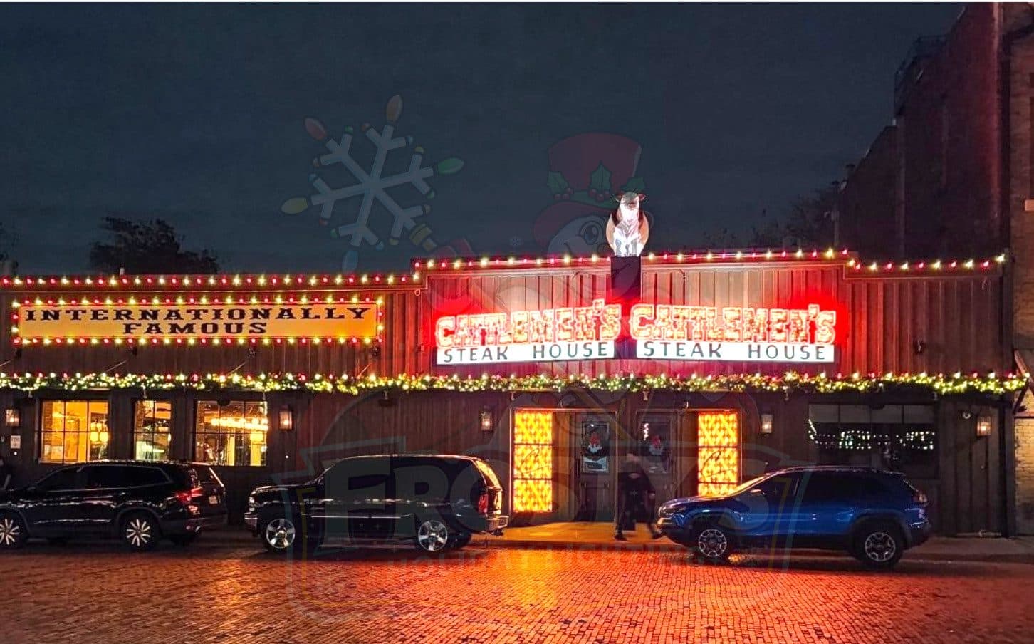 Cattlemen's Steak House in the Fort Worth Stockyards at night with the front roofline and sign outlined in lights